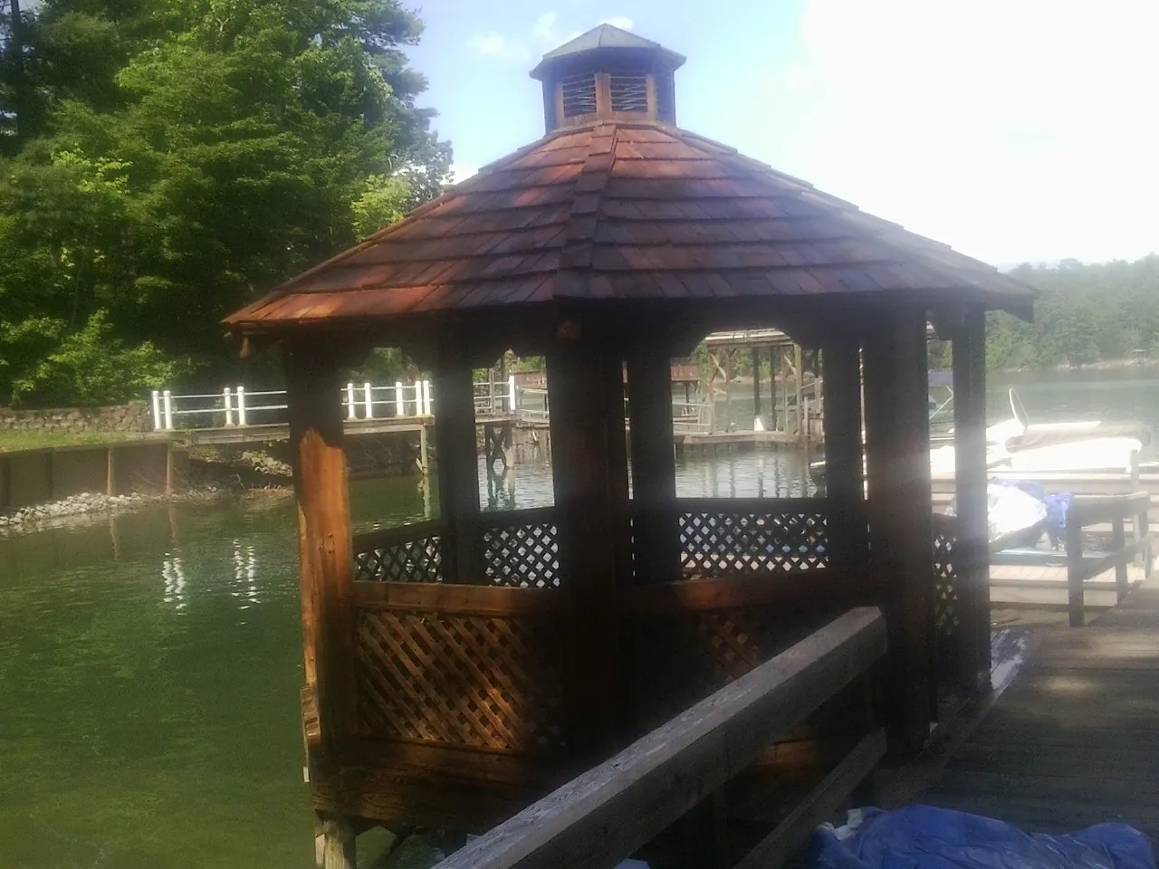 Cedar shake gazebo roof rebuilt on a lake dock in West New York
