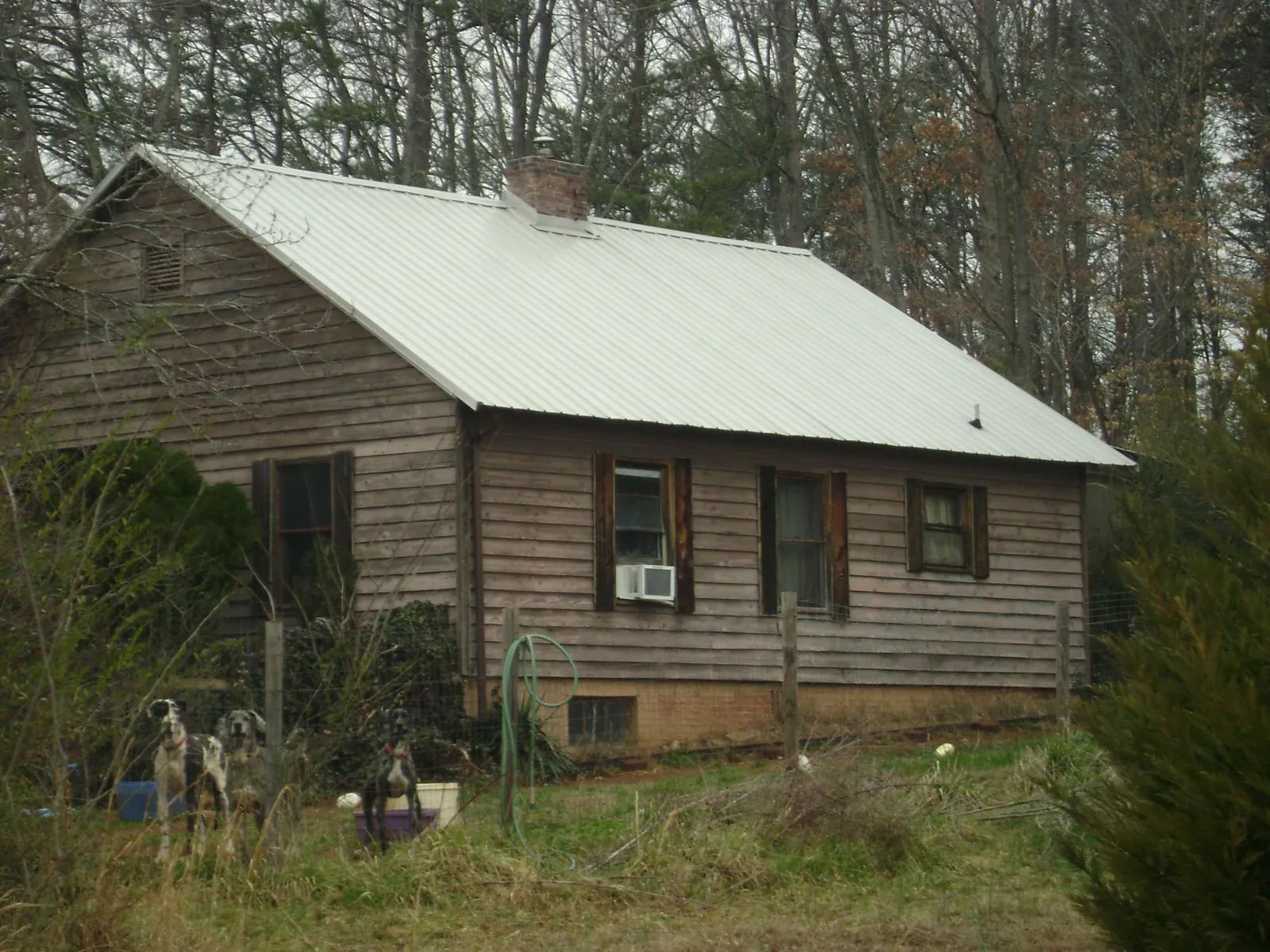 White metal roof on an old wood sided farmhouse, from a Metal Roof Installation job in West New York